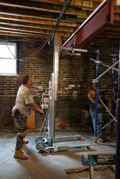 Because space was limited, the new steel beam had to be lifted in two sections, using a Sumner material lift.