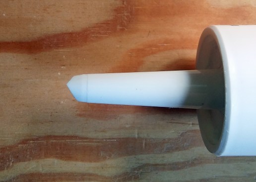 Two ways to cut the tip on the end of a tube of caulk: Rather than one angle, cut two opposing angles as shown above. Note that one cut is deeper than the other; they are not symmetrical.