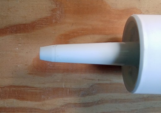 Two ways to cut the tip on the end of a tube of caulk: Or, try a square cut (above); it is easier to control at a consistent angle, and delivers a healthier bead of caulk. By contrast, the long point of a single angled cut can drag through and deform the bead.