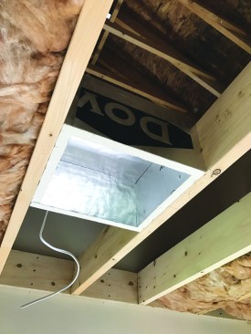 To make it easier to air-seal and insulate the new ceiling, the author assembled light-housing boxes made from foilfaced rigid foam.