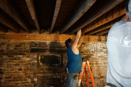 Working together, Toby and Ernesto Bonilla sister new LVLs to the existing joists.