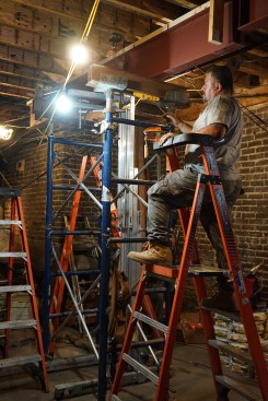 The second beam section is lifted into place and shoring erected to safely support it.