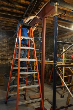 The author bolts the top of the steel columns to the bottom flange of the beam.