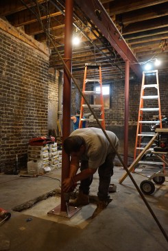 The columns are sized to allow a steel shim to slip below the base; non-shrinking grout is added below each base before it is bolted down with Simpson Titan HDs