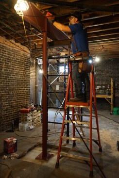 The author toenails through the nailer on the beam into the joists to keep them from rotating.
