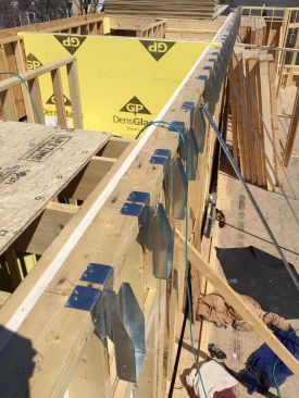 Another look at the specialized truss hangers, which allow wood floor framing to be isolated from wall framing by fire-resistant gypsum board.