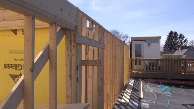 A view along the roof of the older adjacent building toward its roof access structure and deck. This wall will receive a three-foot fire-resistant barrier rated for two hours.