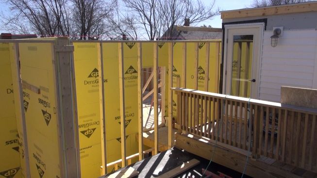 The fire-protected stairwell for the new building rises up above the roof of its older neighbor. This section of wall will receive a two-hour "burn wall" at this location, extending three feet above the neighboring structure.