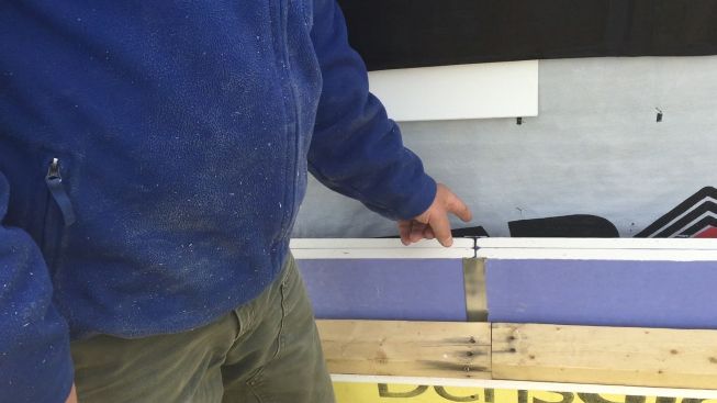 Contractor Rob Paisley shows the two-hour "burn wall" he's installing level by level as he frames each floor of the new building.