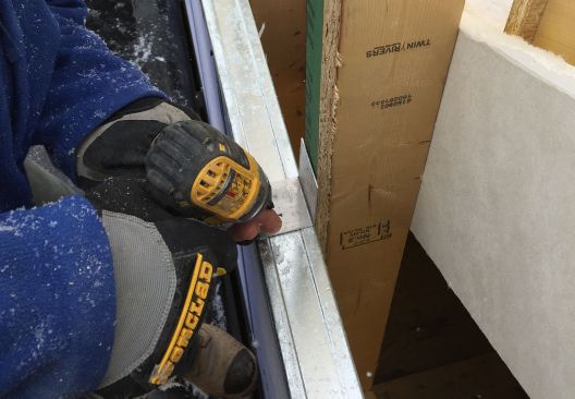 Screwing the aluminum clip to the steel C-channel.