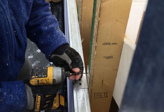 Paisley screws the breakaway aluminum clip to the stud wall.