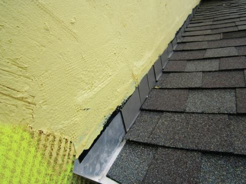 Apply a layer of mesh and liquid WRB to the top edge of the step flashing (shown) and to the top of the counterflashing.