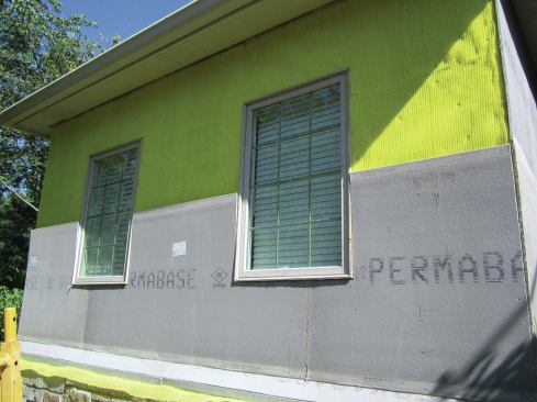 The DEFS base panels, which replace the insulation panels of an EIFS assembly, are installed over the drainage layer. 