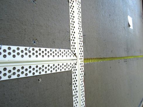 ... and by installing a vinyl strip that will accordion in and out as the wall swells and shrinks.