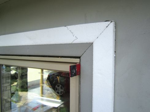 Once the base coat has cured, foam trim is applied 3/8 inch away from the edge of windows and doors.