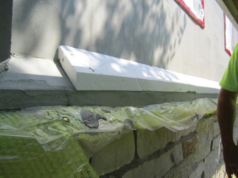 The beveled EPS base will be covered with the stucco base coat.