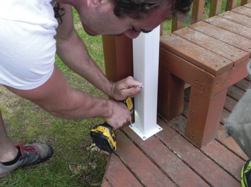 Post base plates are screwed to the bottom of each column and to the deck, which must be properly blocked to support the loads.