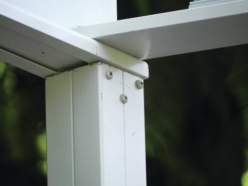 Beam-to-column connections are made by sliding post-top shoes into an I-beam’s bottom channel, then inserting the shoes into the tops of the columns.