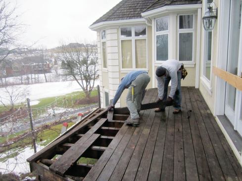 Demo begins with removing the old cedar deck boards.