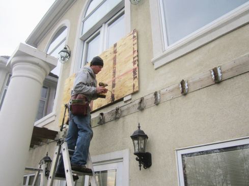 Moisture-meter readings at the ledger and below windows were abnormally high, indicating possible rot beneath the EIFS cladding. It would need to be removed above and below the ledger for the state of the sheathing to be assessed.