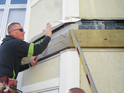 Before installing the new ledger, workers installed new metal flashing over the EIFS, and an SAF membrane over the sheathing.