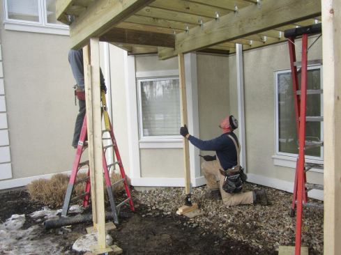 Workers temporarily supported the deck framing with posts while they waited for the new fiberglass columns to arrive.