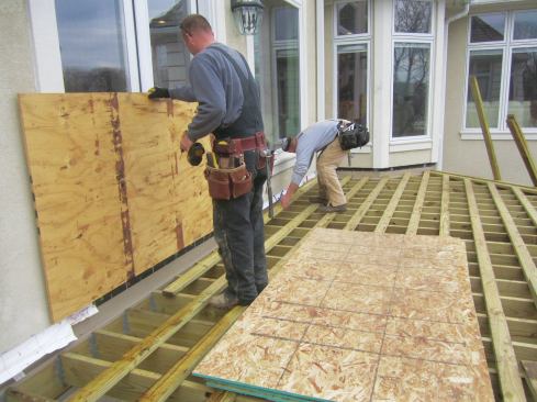 The new deck was framed with joists 12 inches on-center. To support the pavers, workers then screwed 2x4 sleepers to the tops of the joists, also 12 inches on-center.