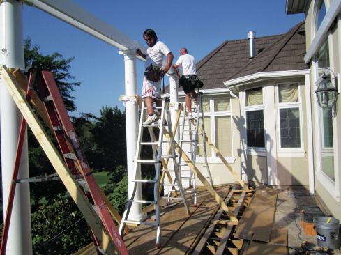 The pergola’s double support beam is through-bolted to the steel columns.
