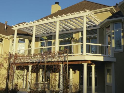 A single beam fastened primarily through the window trim and into the framing supports the pergola rafters on the house-side.