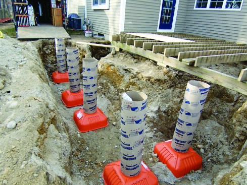 Figure 2. With an excavator on site for other work, setting the footings in a trench allowed accurate layout and minimal shovel work.