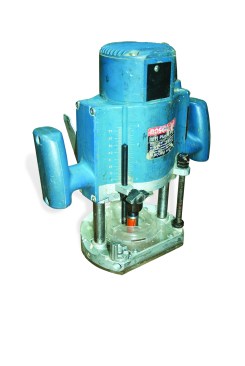 Figure 2. The plunge router’s release lever allows the motor and bit to move up and down. Depth of cut can be preset.