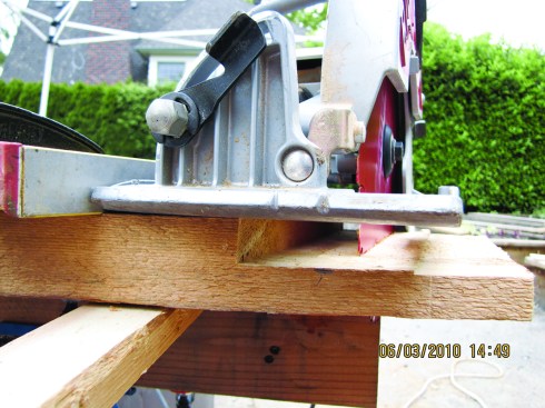 Figure 17. Adjust the straightedge as needed to guide a circular saw in cutting the work to length.
