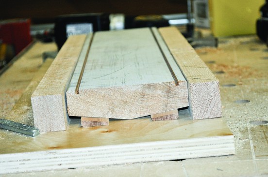 Figure 19. To hold profiled stock, make one jig that grips its edges, and tape or hot-glue wedges to the jig to stabilize the workpiece. 