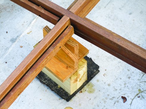 Figure 5. Pairs of marine-plywood ramps slide past each other to raise the grid member to the correct height and are then screwed fast. 