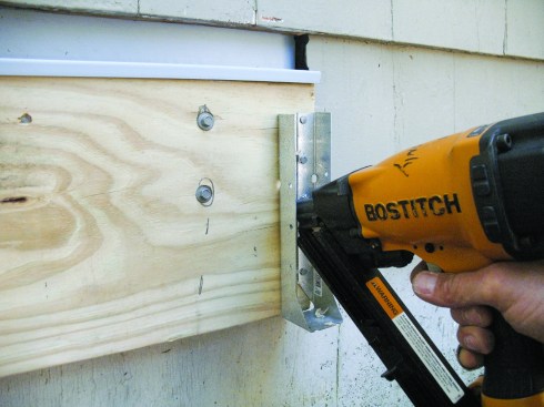 Figure 4. Concealed-flange hangers are fastened to the ledger with nails through the folded-in flanges. 