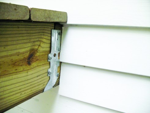 Figure 5. Although commonly done, field modifying a joist hanger at the end of the ledger by flattening its flange ruins its integrity.