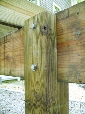 Figure 10. Notching a seat in a 6x6 post and bolting the upper part of the post to the girder provides a connection that resists rolling as well as uplift. 