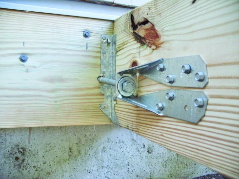 Figure 17. One solution to the 2009 IRC’s lateral-attachment requirement is this hold-down-type hardware, applied to joists both on the deck and inside the house. 
