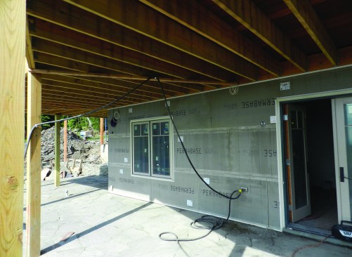 Above grade on the walk-out side, we installed PermaBase over the ICFs. This provided a nail-base to which we could apply the same rainscreen material and scratch coat that we used on the rest of the above-grade walls.