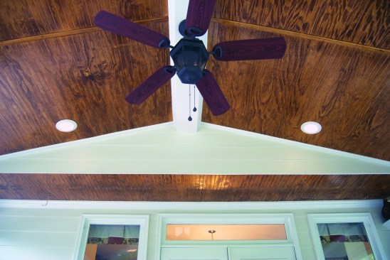 It may be necessary to incorporate structural features of the existing house, such as this second-floor cantilever, into the porch ceiling.