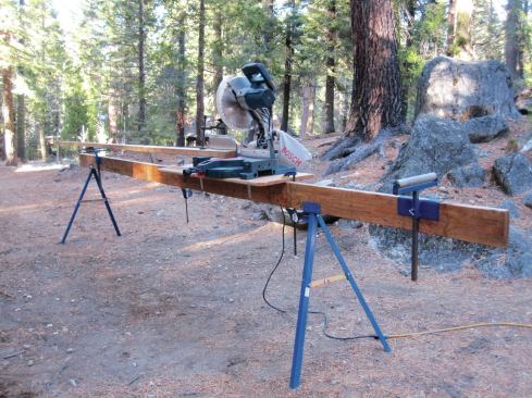 When the clamping screws stripped on Greenlaw’s saw table, he cut a larger top, so it could hold other tools, and replaced the stock mounting bracket with two opposing pairs of shelf brackets that slide over the 2-by rail. Now he just screws or clamps the table to the rail.