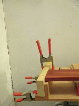 JLC executive editor and veteran carpenter Clayton DeKorne simply clamps or bolts his miter saw to a slab of plywood and sets it on sawhorses or another stable surface. The outboard work supports consist of plywood L-brackets that are ripped to the same height as the saw table.
