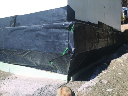 We observed large air bubbles under the membrane, as well as areas missing counterflashing.