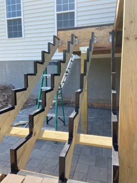 Cutting a stringer creates “end grain” at each stair tread and riser. End grain absorbs water up to 100 times faster than the sides of the lumber do. As such, cut edges of the 2x12 preservative-treated southern pine stringers are flashed.