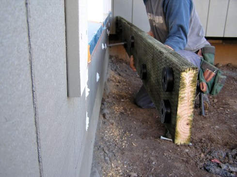 Deck2Wall’s code-approved spacers are fastened to the back of the ledger to promote drainage between the house and ledger.