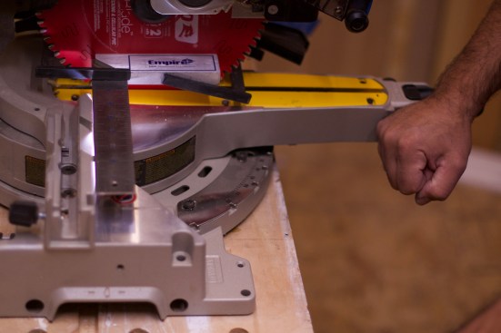 Loosen the miter plate screws and gently tap the end of the table until the light disappears.