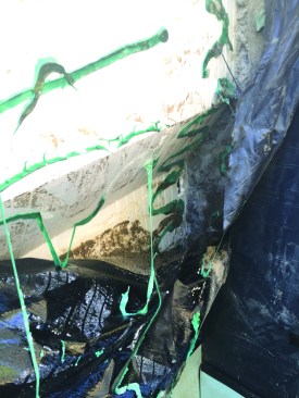After more excavation, we discovered the major issue. A thick green membrane sealant meant for seams had been used on large areas instead of the recommended primer. The thickness of the sealant had prevented the sheet membrane from fully adhering to the ICF.