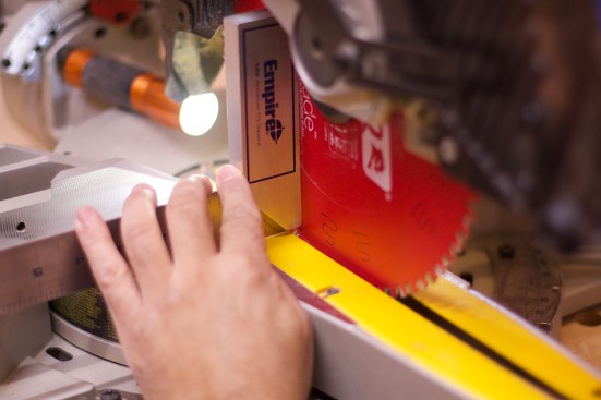 Set a square against the table and press it lightly to the blade.