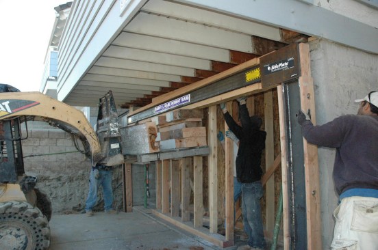Raising the frame. For retrofit applications with the frame installed within the existing wall line, raise the moment frame until the 3-by nailer on top of the beam is in contact with the building collector. Once the moment-frame assembly is correctly positioned, check that it is plumb and install temporary shoring.