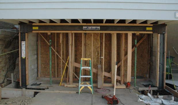 Ready for concrete. In this photo, the Hardy Frame SMF is installed and ready for concrete to be poured at the footings. Connectors to transfer shear from the blocking in the floor system to the wood nailer on top of the SMF beam will be framing angles, as specified by the Engineer of Record. The label shown on the left column provides illustrations of typical bottom and top connections for the installers and the building inspector’s reference.